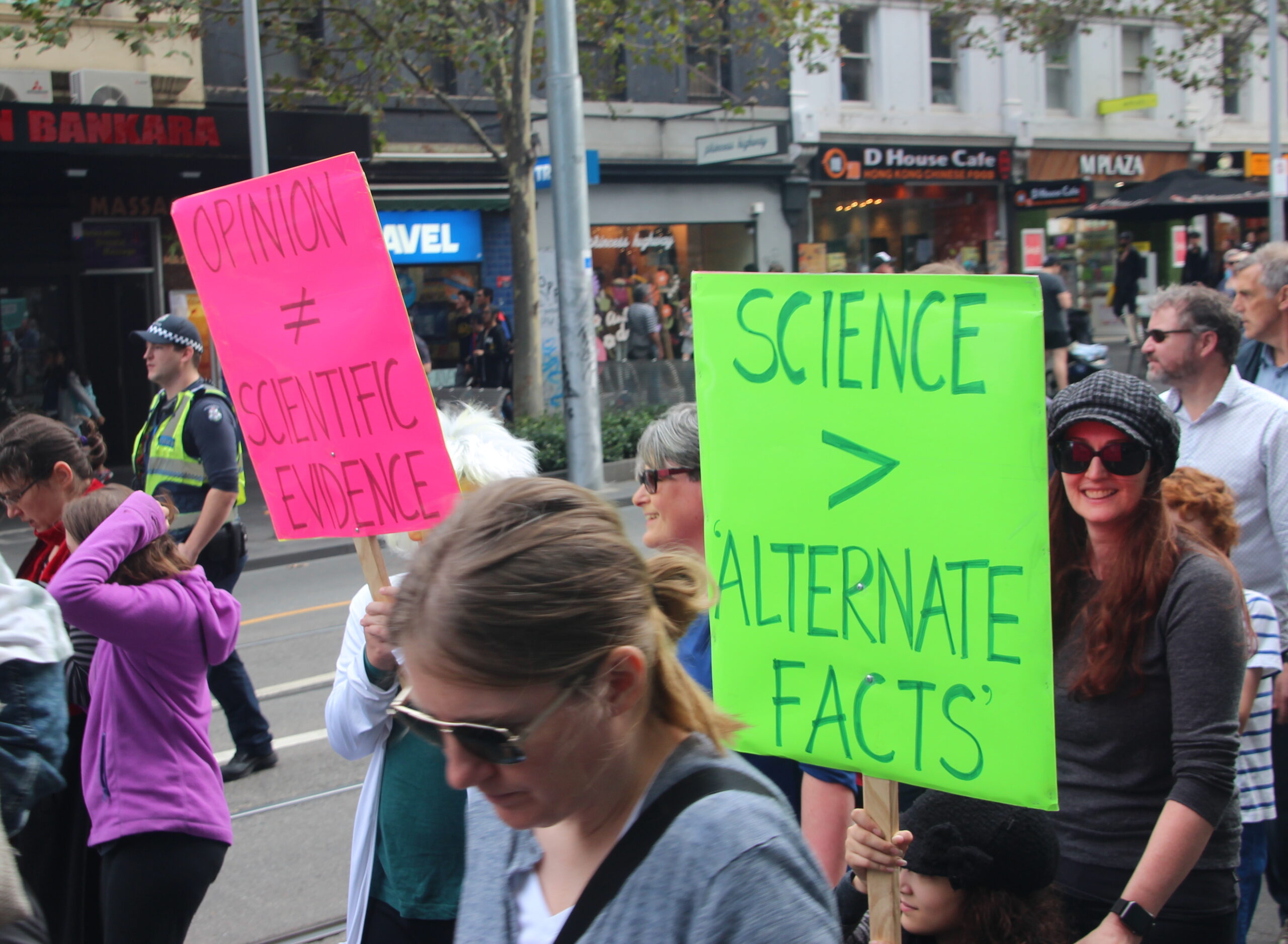 Demonstrator holding a sign to protest disinformation.
