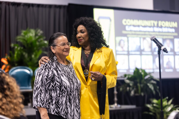 Dr. Beverly Wright (right), founder of the Deep South Center for Environmental Justice, presents Susana Almanza with an EJ Groundbreakers Medallion.