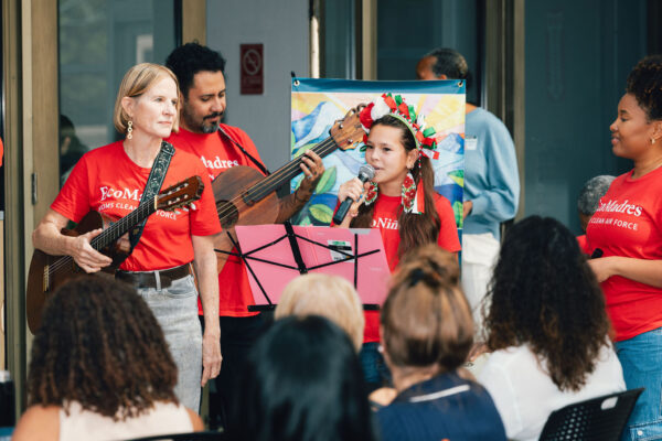 Multi-ethnic Latin music ensemble, SonTierra performing      a call and response song with the attendees.
